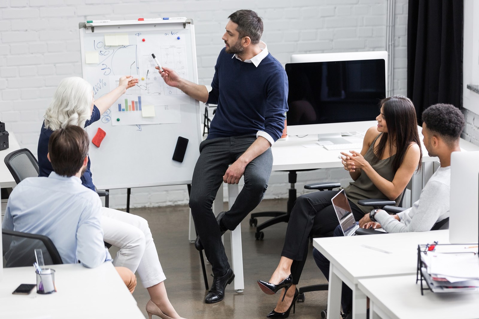 Creative People Sitting At Table In Boardroom